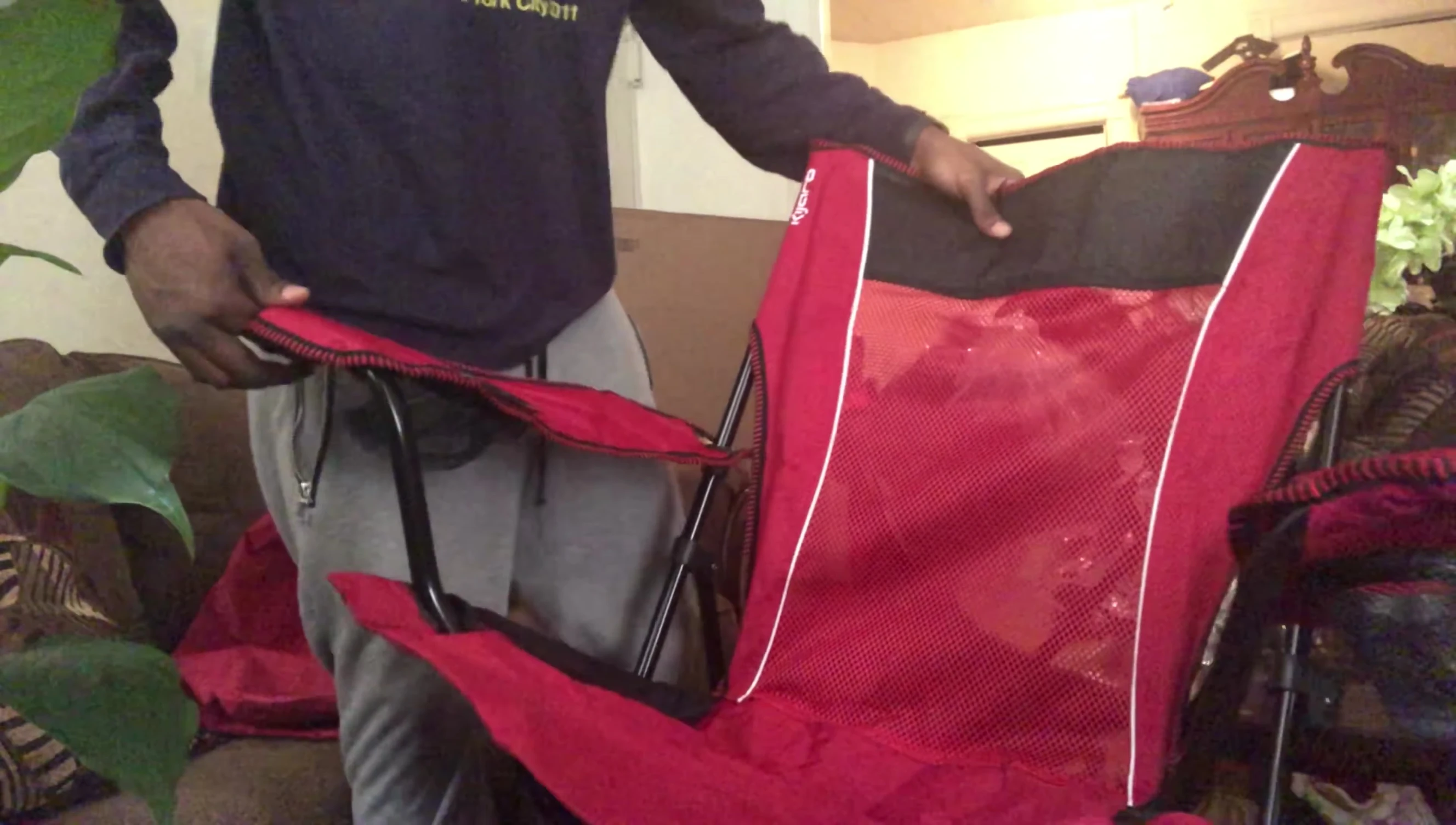 The reviewer sitting in the unfolded Kijaro Dual Lock chair.