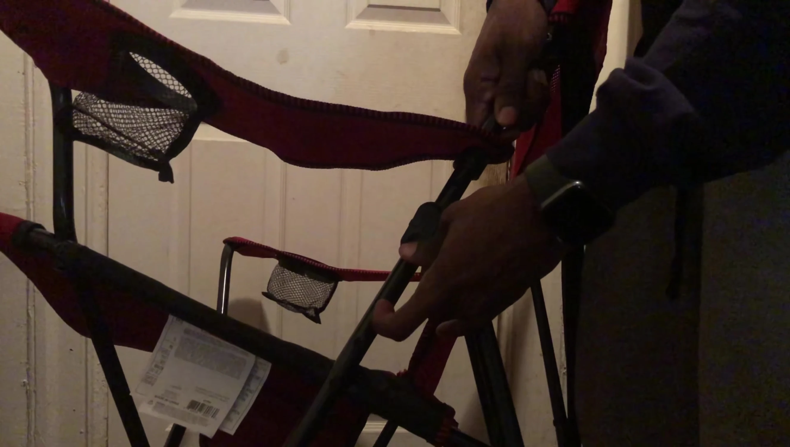 Demonstrating how the chair folds and locks for storage.