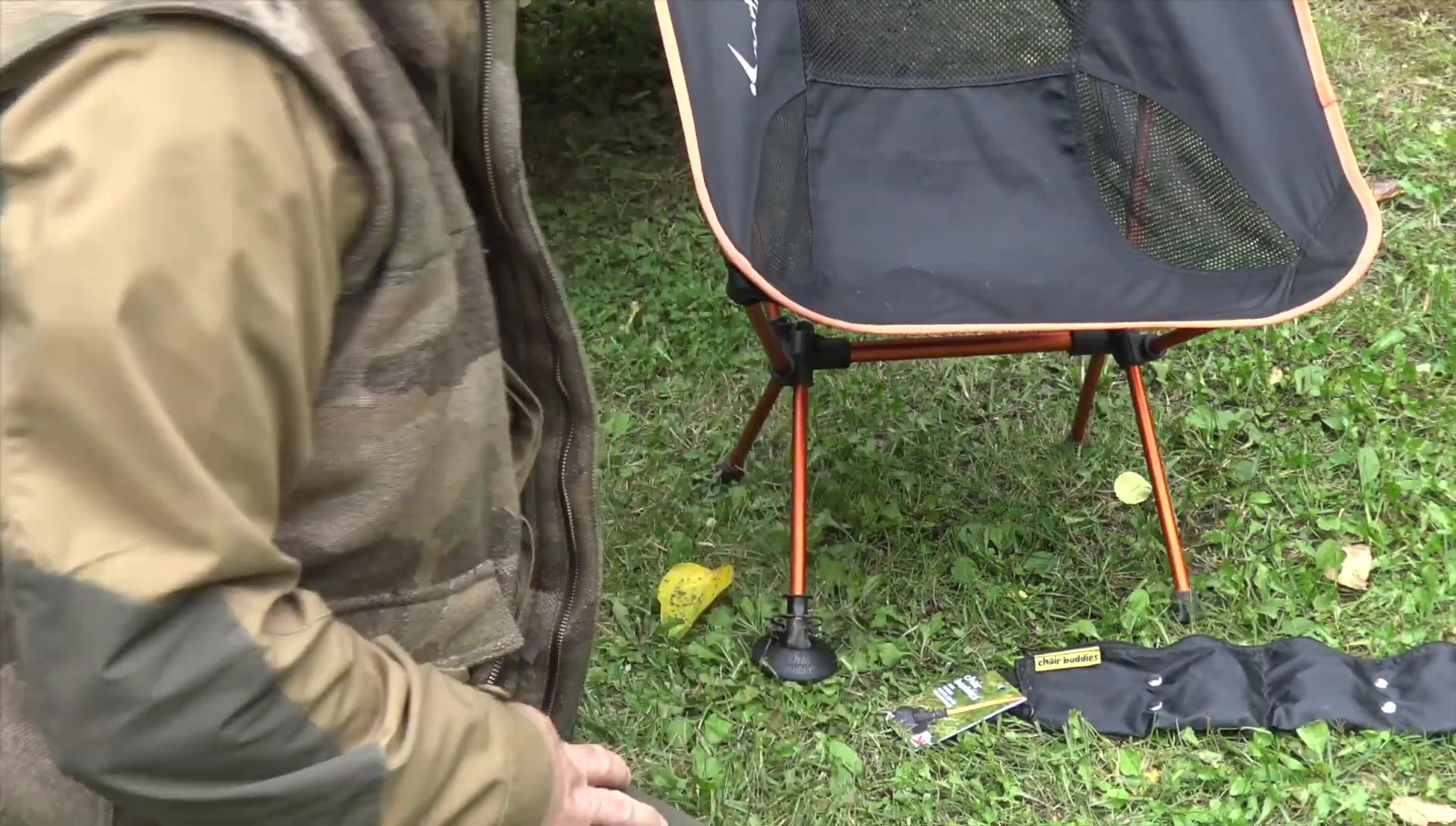 The reviewer attaching a Chair Buddy to a chair leg.