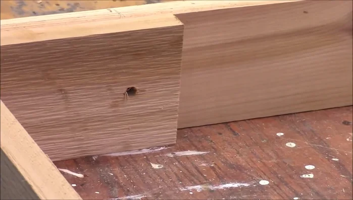 Add angled oak supports to assist leg folding and frame rigidity.