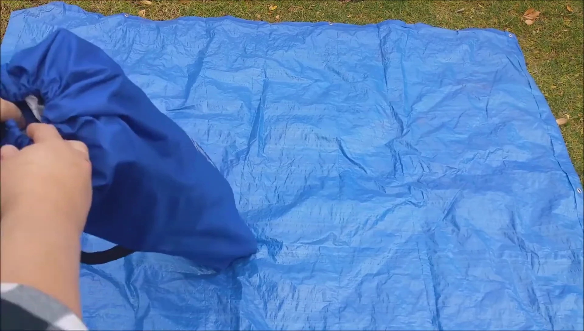 The KingCamp folding camp cot in its drawstring carrying bag.