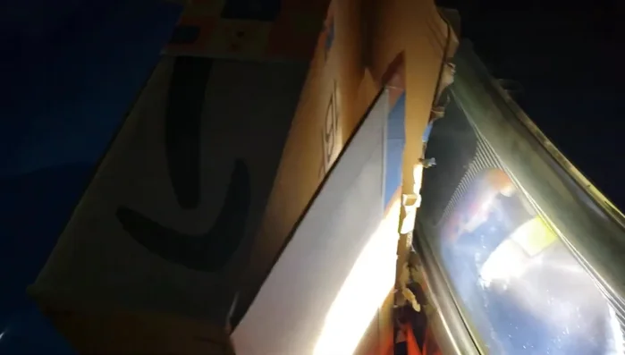 Turn on your headlights. Use a cardboard box or similar object to block one headlight at a time to better observe the beam pattern.