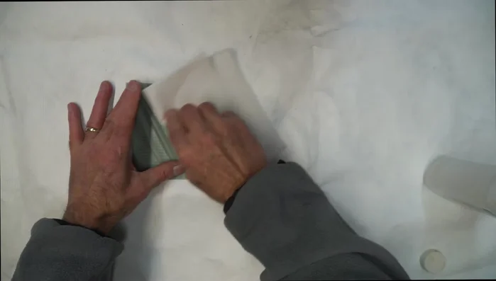 Apply tape to the back of the patch to prevent wrinkling during application.