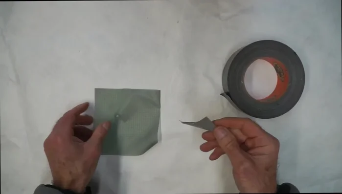 Apply tape to the back of the patch to prevent wrinkling during application.