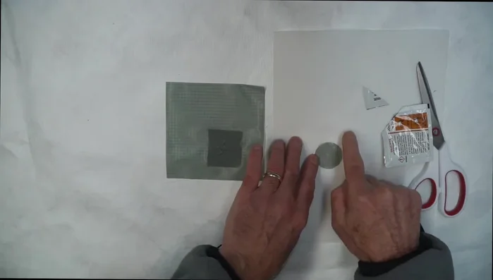 Use a putty knife or credit card to smooth out excess silicone and press the patch firmly.