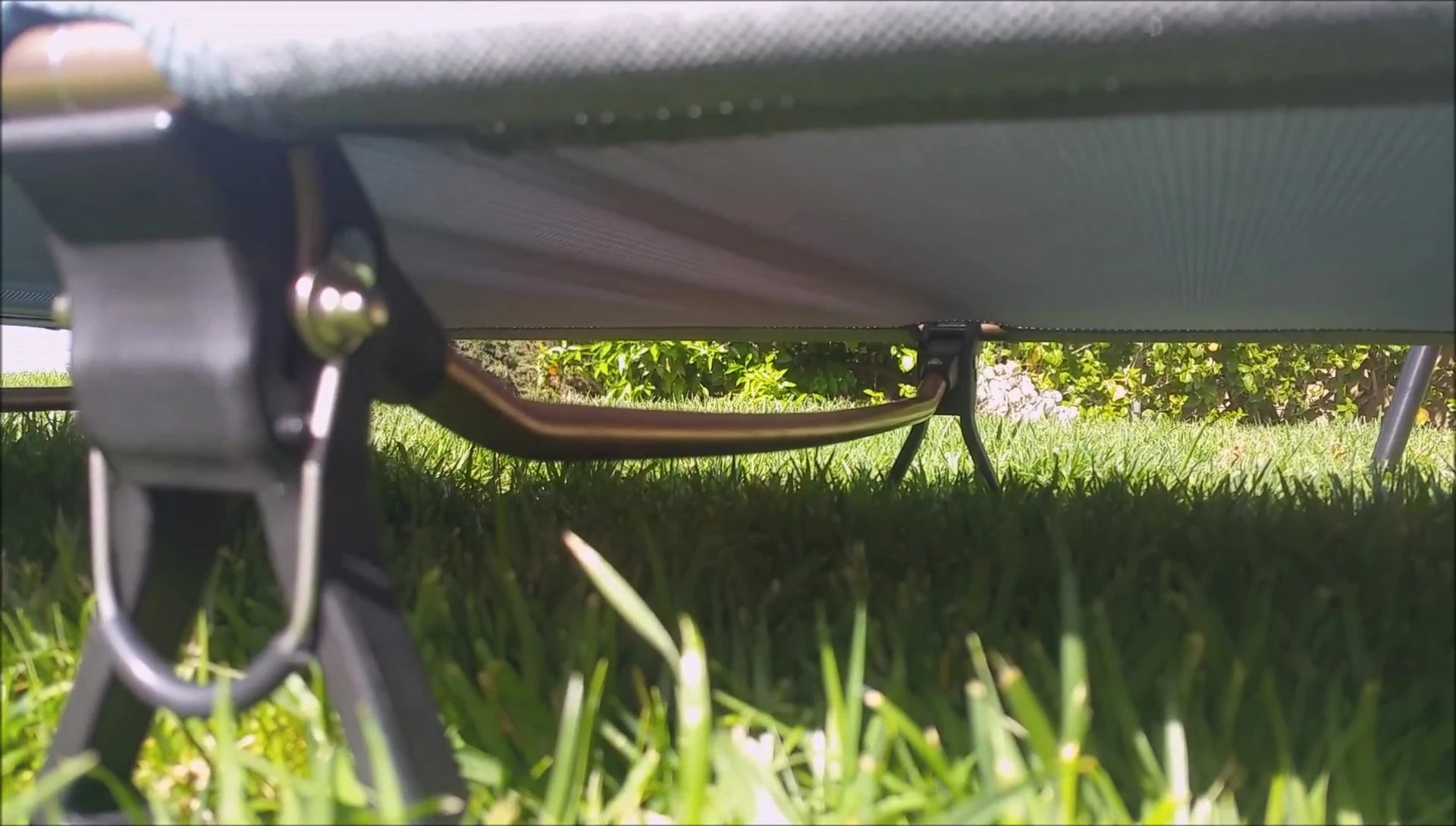 Close-up view of the underside of the cot showing the support bar.