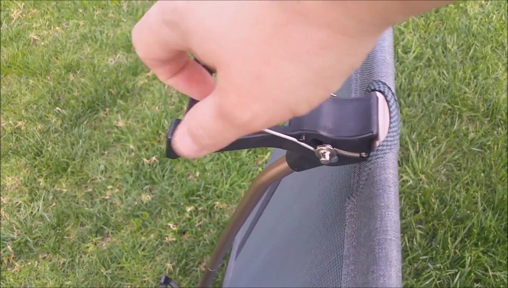 The reviewer demonstrates the process of releasing a locking pin.