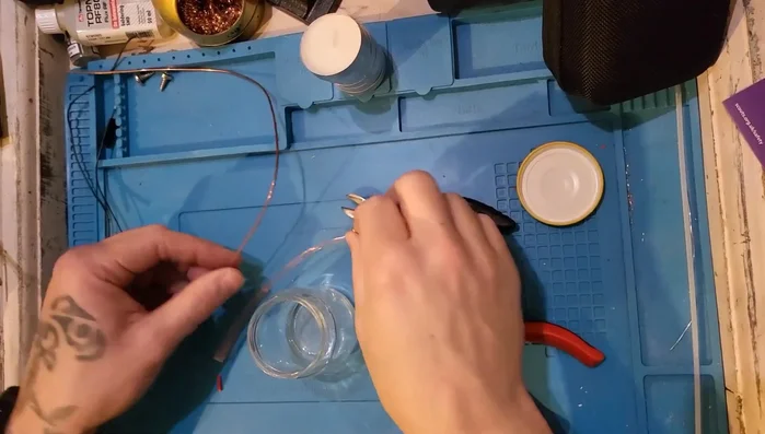 Shape and adjust the wire to ensure it fits the jar comfortably and the handle is secure.