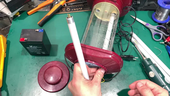 Install the new warm-colored CFL tubes, ensuring proper seating.