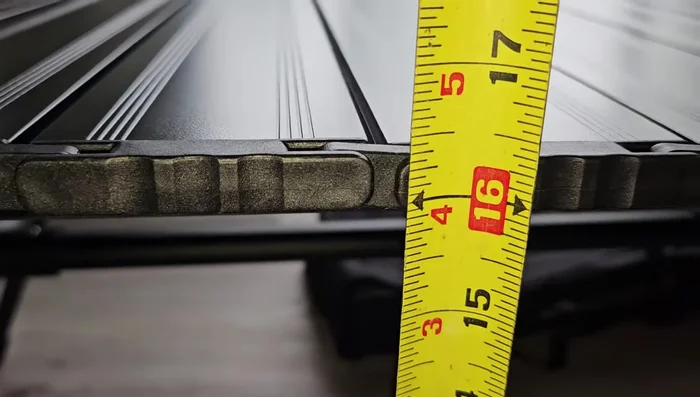 Adjust the table height to either the lower (approx. 16-16.5 inches) or higher (approx. 21 inches) setting.