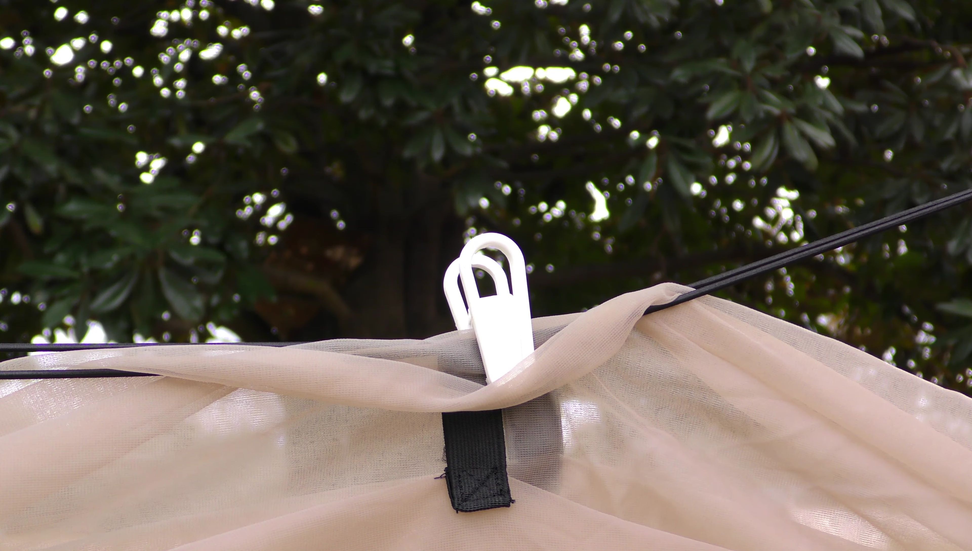 The reviewer demonstrating their modification to adjust the mosquito netting.