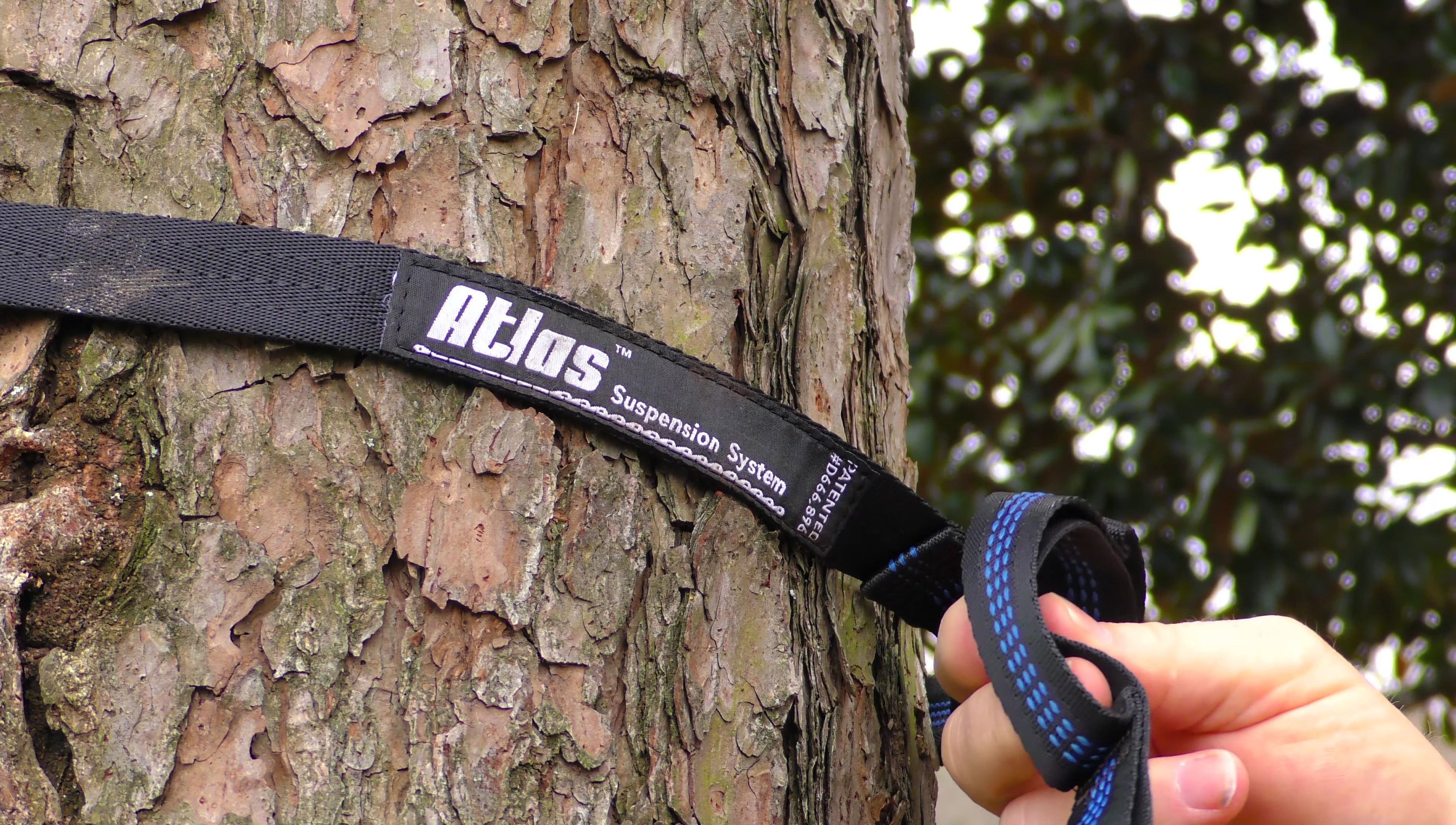 The reviewer hanging the hammock with their Atlas suspension system.