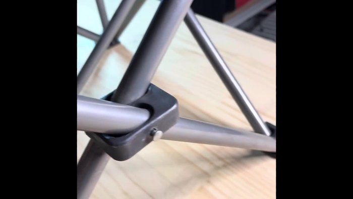 Identify the broken rivet on the fishing rod holder.