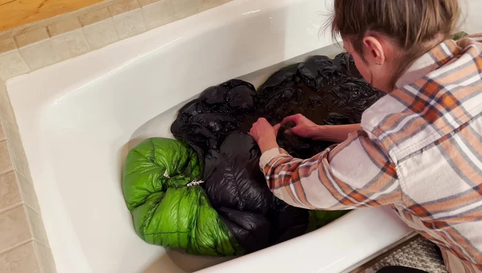 Agitate and soak: Gently agitate the sleeping bag in the soapy water to work the soap in. Let it soak for about 10 minutes.