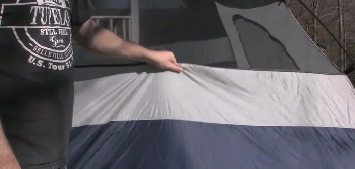 Brush off the bottom of the tent and set it on a clean tarp.