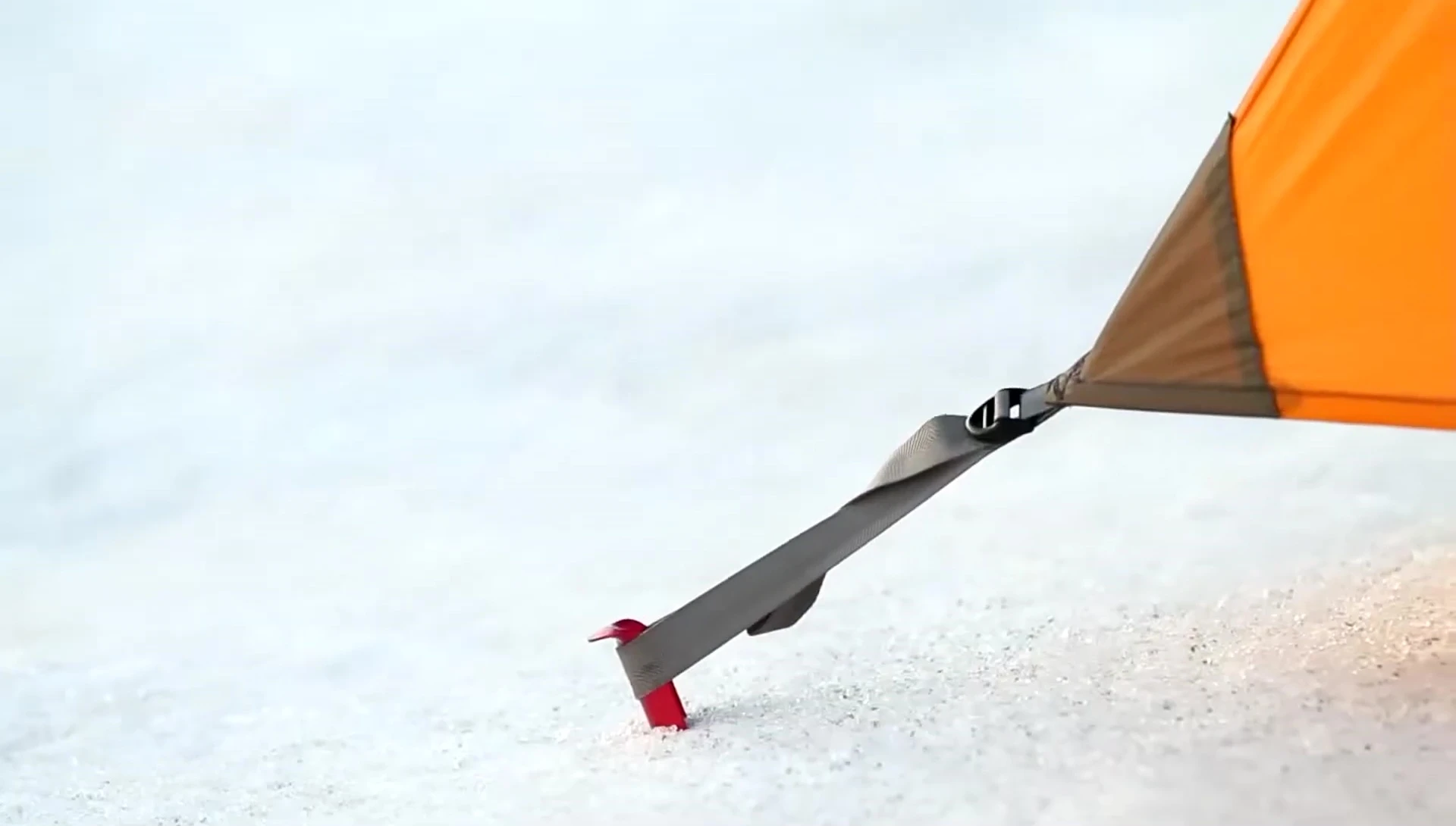 Demonstrating vertical placement of the Blizzard stake in firm snow.