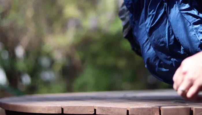 Lay your sleeping bag out flat for 30 minutes to an hour.