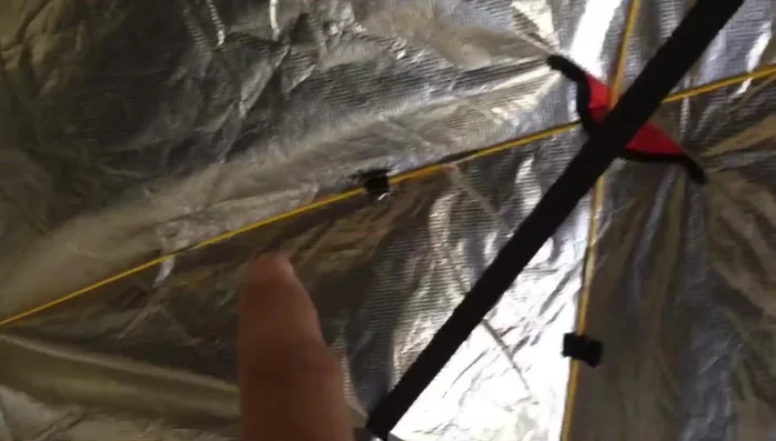 Sew small pockets into the corners of the emergency blanket to further secure the support poles.