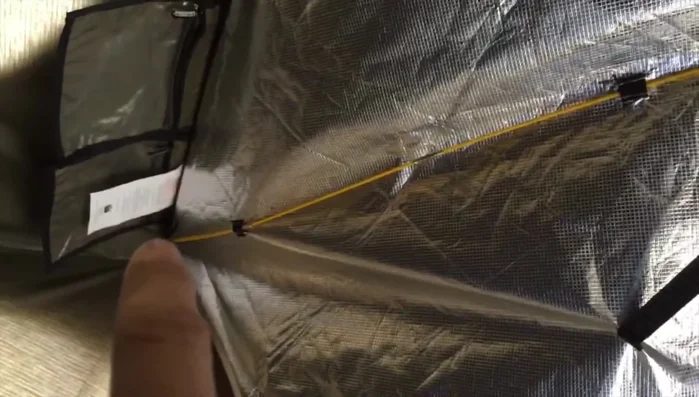 Sew small pockets into the corners of the emergency blanket to further secure the support poles.