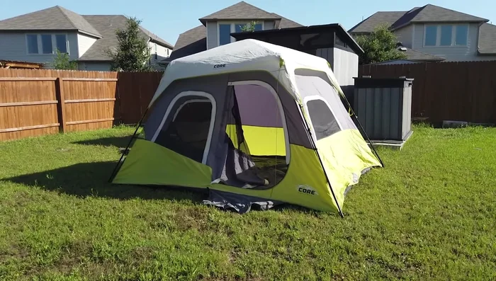 Review of the REI Co-op Base Camp 6 Tent: Sturdy, all-season, accommodates four, spacious interior with large vestibule, durable construction.