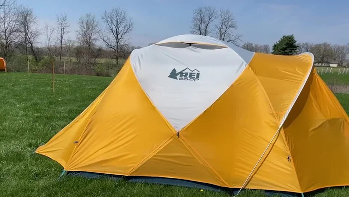 Review of the REI Co-op Base Camp 6 Tent: Sturdy, all-season, accommodates four, spacious interior with large vestibule, durable construction.