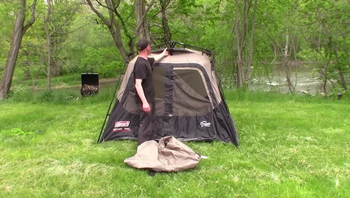 Review of the REI Co-op Base Camp 6 Tent: Sturdy, all-season, accommodates four, spacious interior with large vestibule, durable construction.