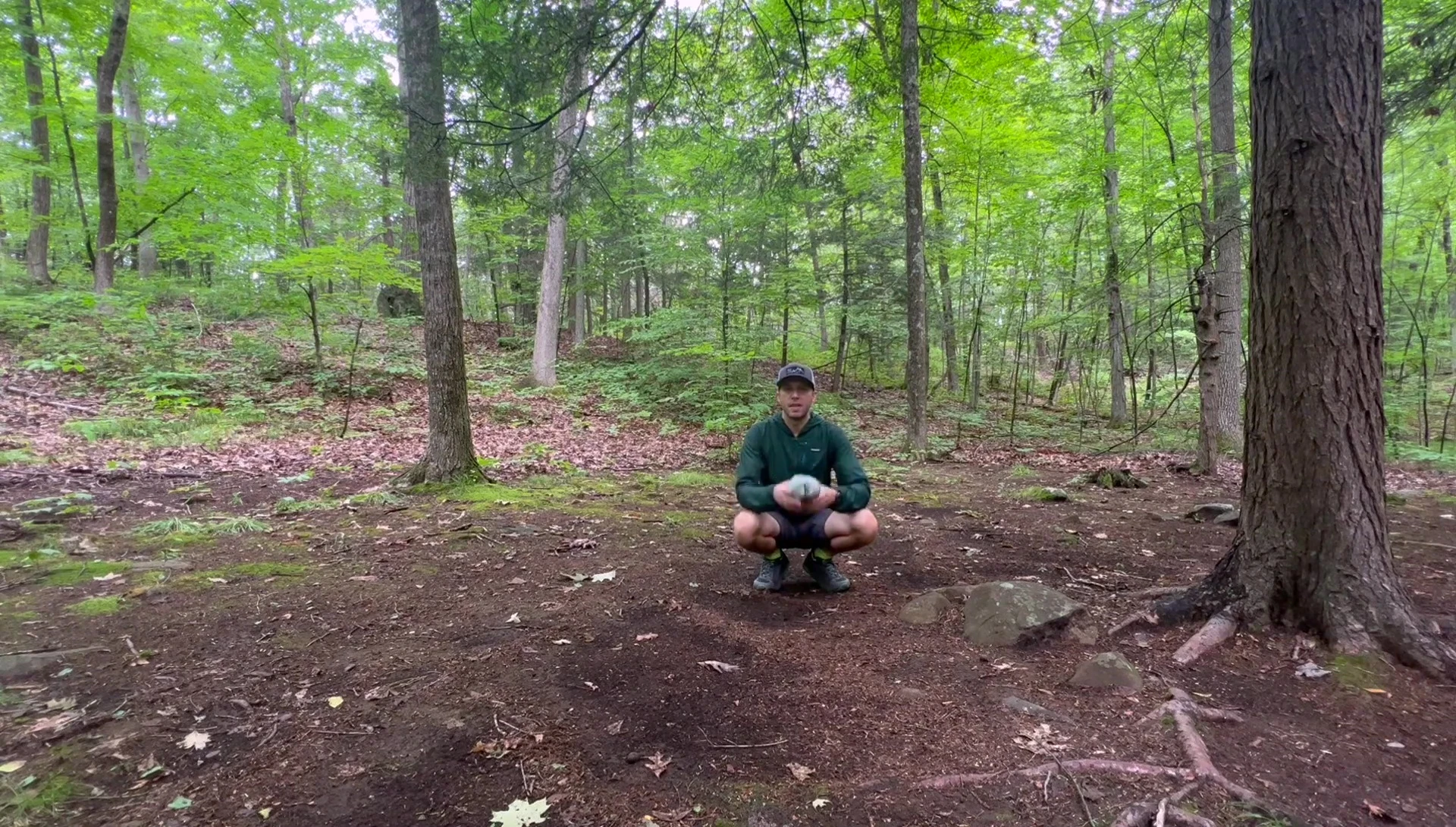 Speaker demonstrating observation of surroundings for ideal tarp placement.
