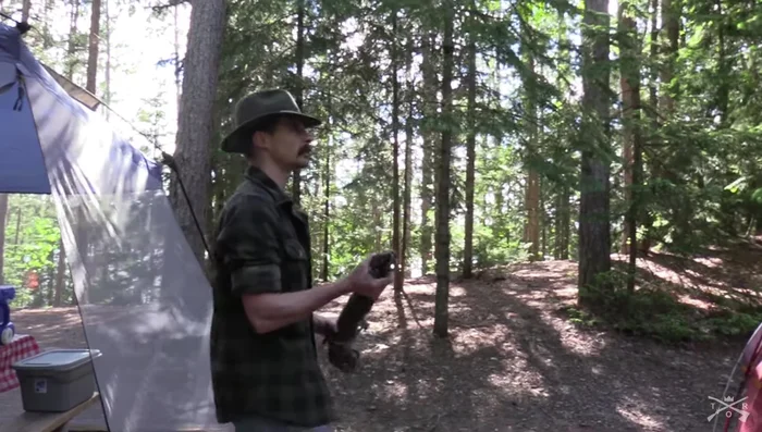 Attach the center rope to the anchor trees, aiming for approximately 10 feet high. Stretch the rope across the tents.