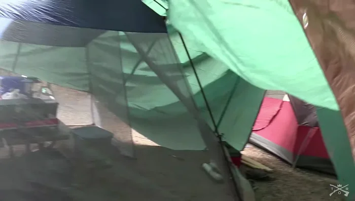 Tighten the side ropes and center rope to straighten the tarp and create a taut setup.