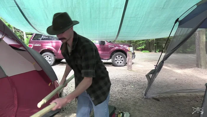 Install center poles using notches and duct tape to secure them to the center rope for added support. 