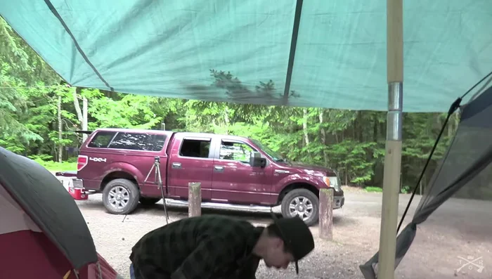 Address any water-pooling areas by using additional ropes and carabiners to create a drainage system.