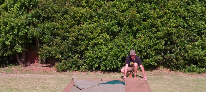 Make a small fold at the back, then repeatedly fold/roll the tent, pressing down to remove air.