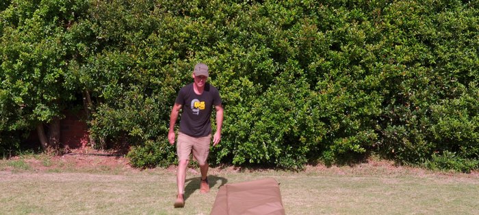 Make a small fold at the back, then repeatedly fold/roll the tent, pressing down to remove air.