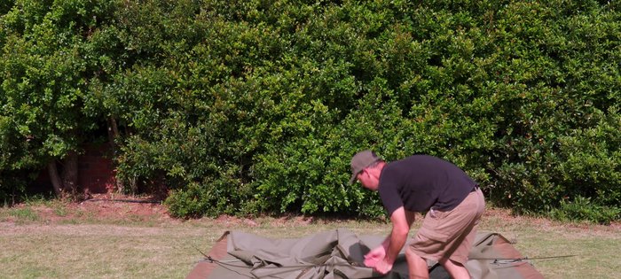 Lower the frame carefully, pull it apart, fold it, and pack it into its bag.