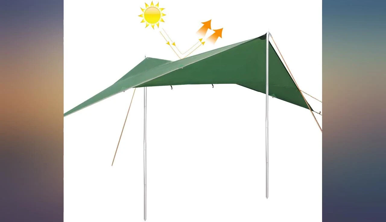 The reviewer setting up the rain fly at a campsite