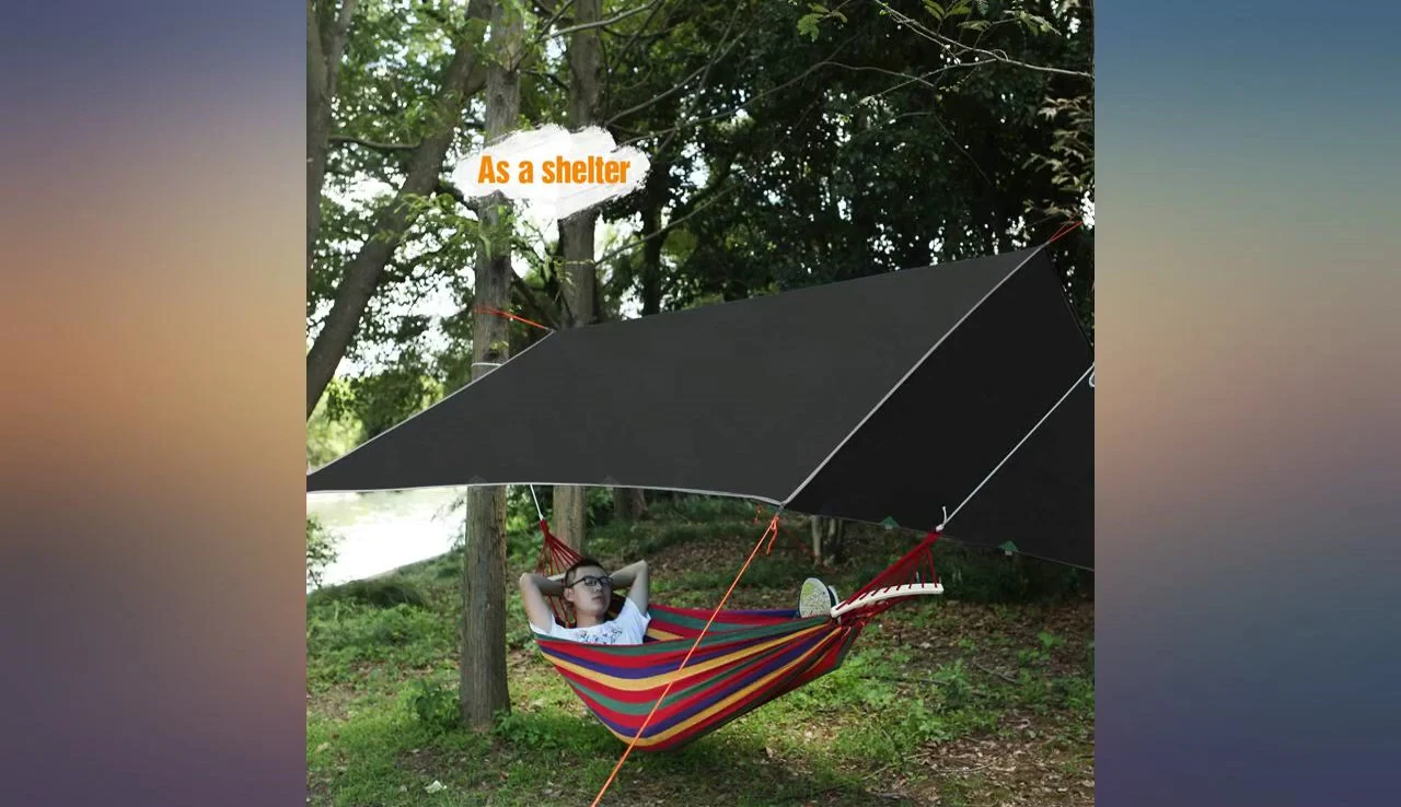 An overall shot of the reviewer using the rain fly.