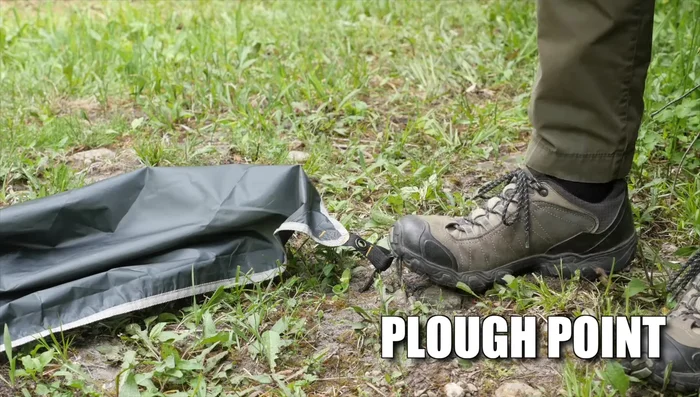 Peg down one corner of the tarp.