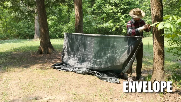 Attach one edge of the tarp to the ground using stakes.