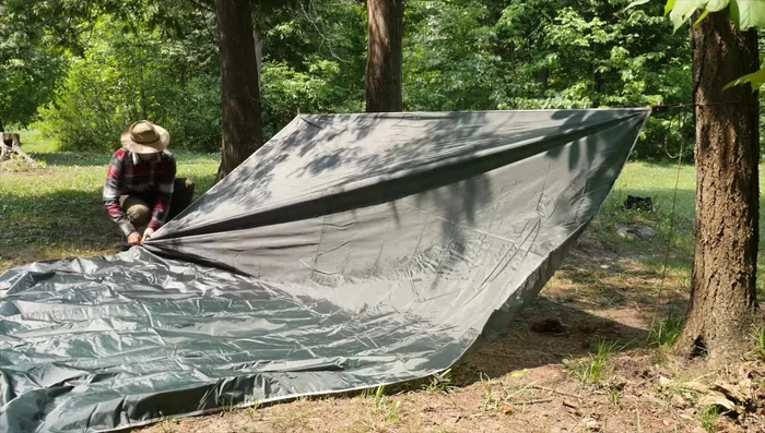Pass stakes through loops at the middle point of the tarp.
