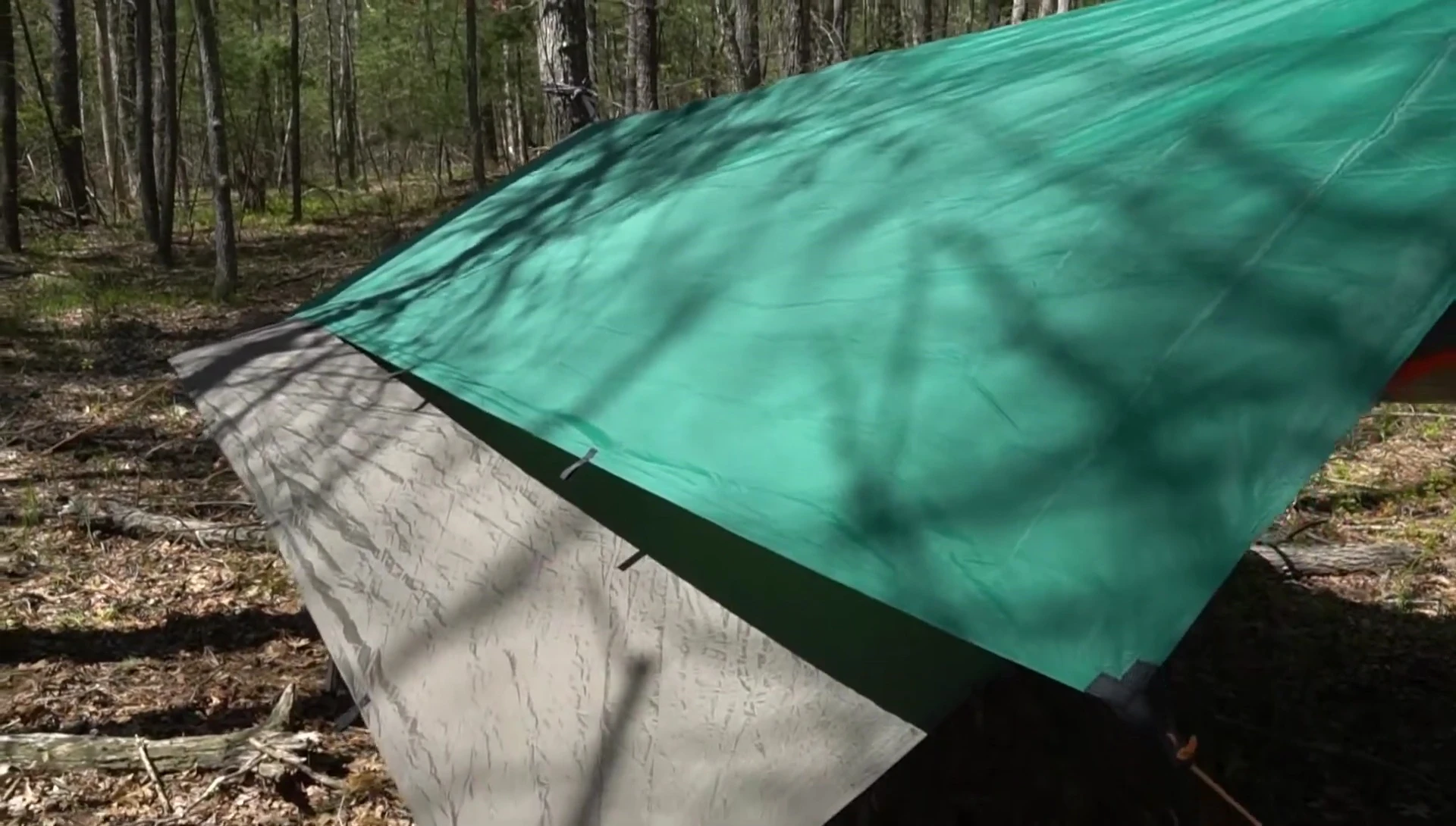 Guide tarp blowing in the wind, demonstrating its lighter weight.