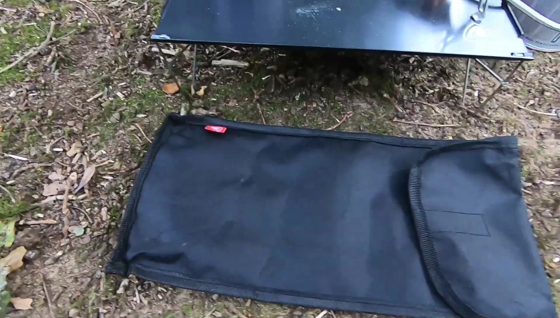 The reviewer attempting to fold the table with one hand