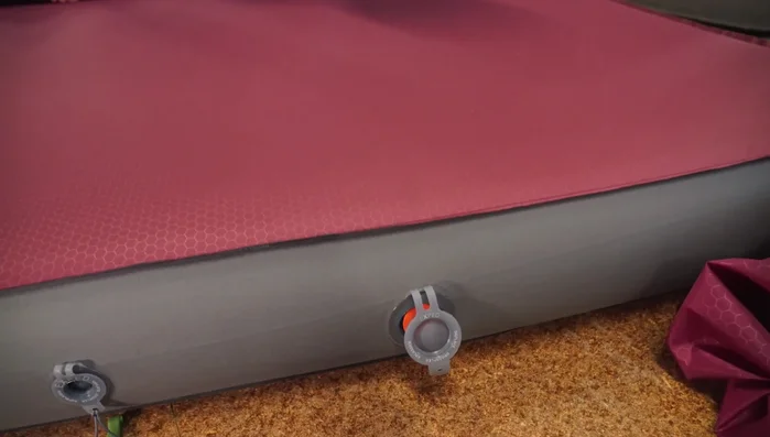 Loosely roll the mat to expel most of the air. Use your hands and knees to squeeze out as much air as possible.