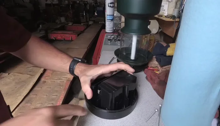 Carefully pry the battery pack from the base. It's held in place by adhesive. Use a flat object to pry gently from behind, avoiding damage to the lantern.