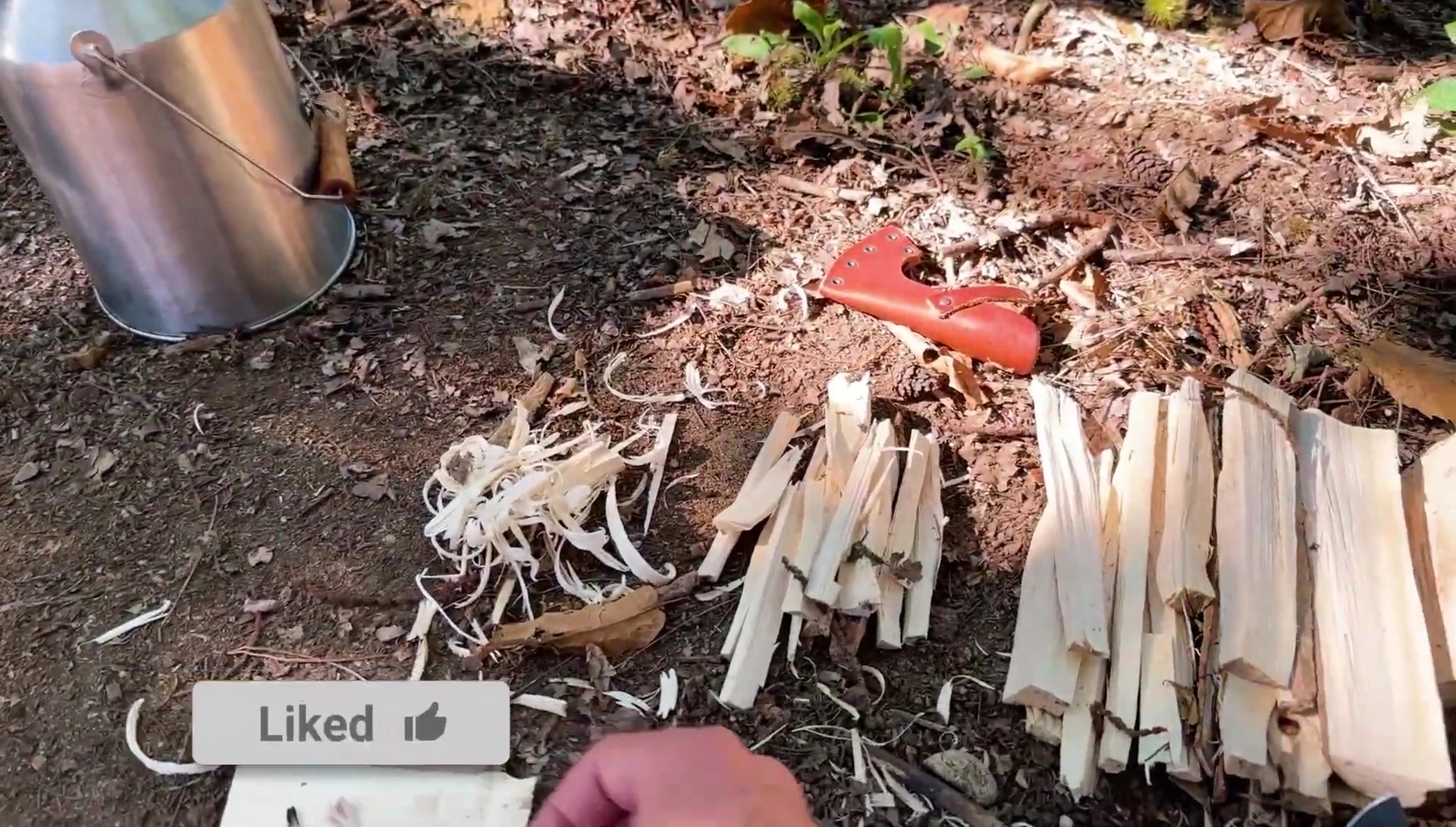 The presenter using a ferrocerium rod to light wax twine.