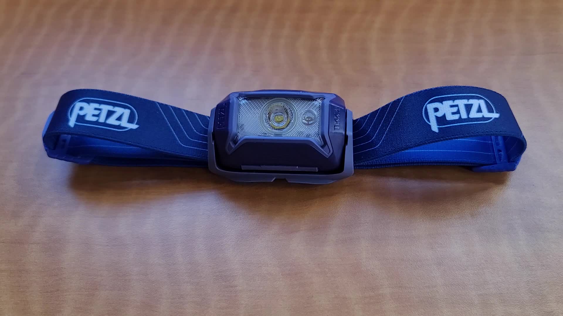 Close-up of the Petzl Tikka headlamp being used for reading