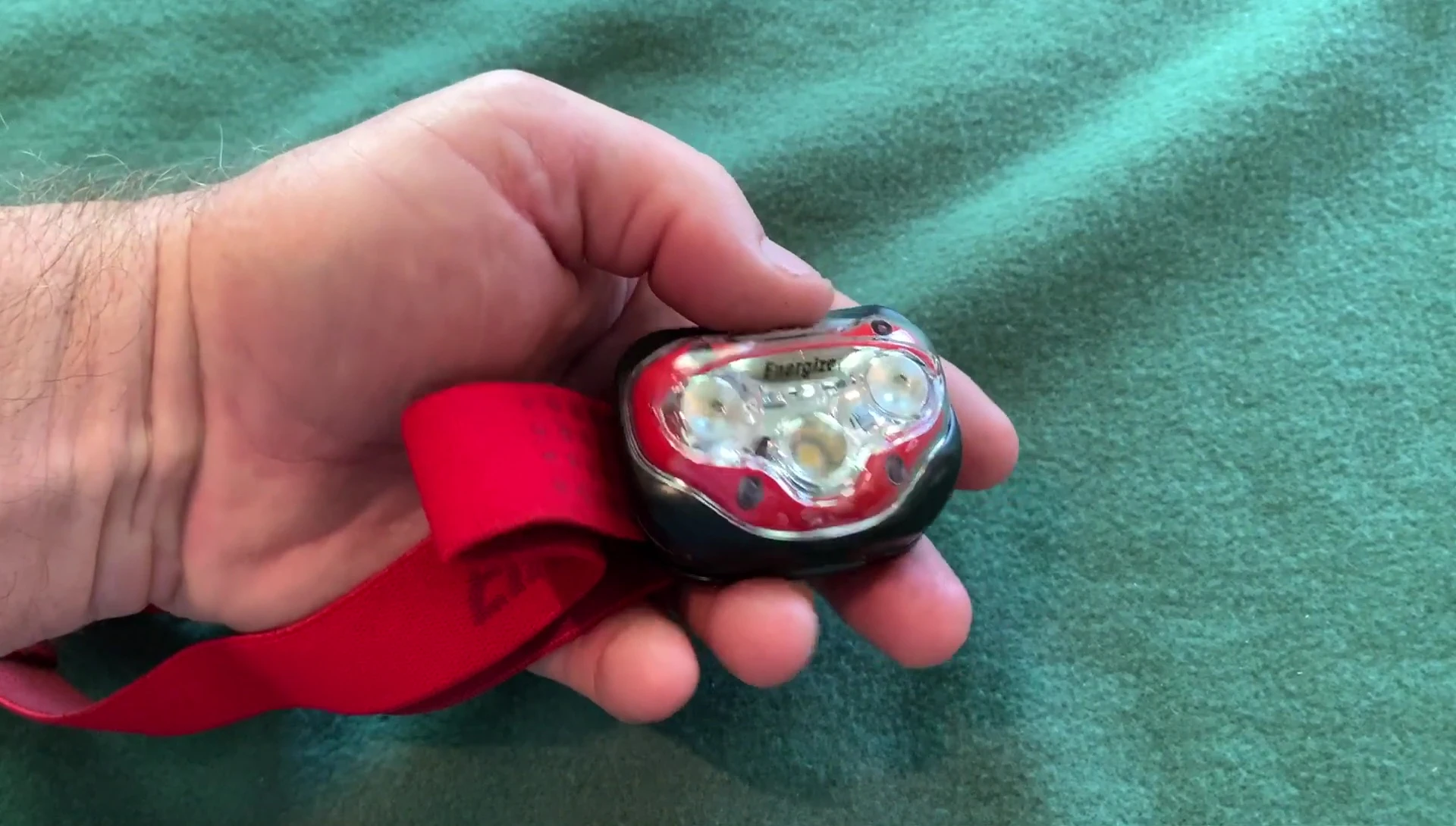 The reviewer testing the headlamp's brightness outdoors.