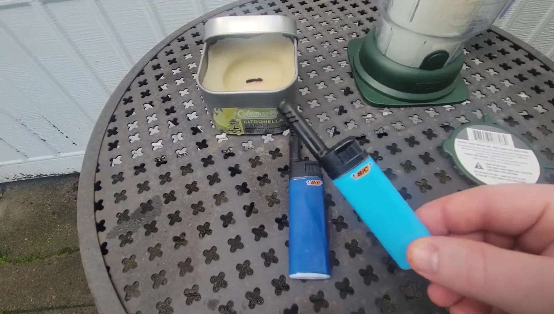 The reviewer showcasing a compact candle lighter.