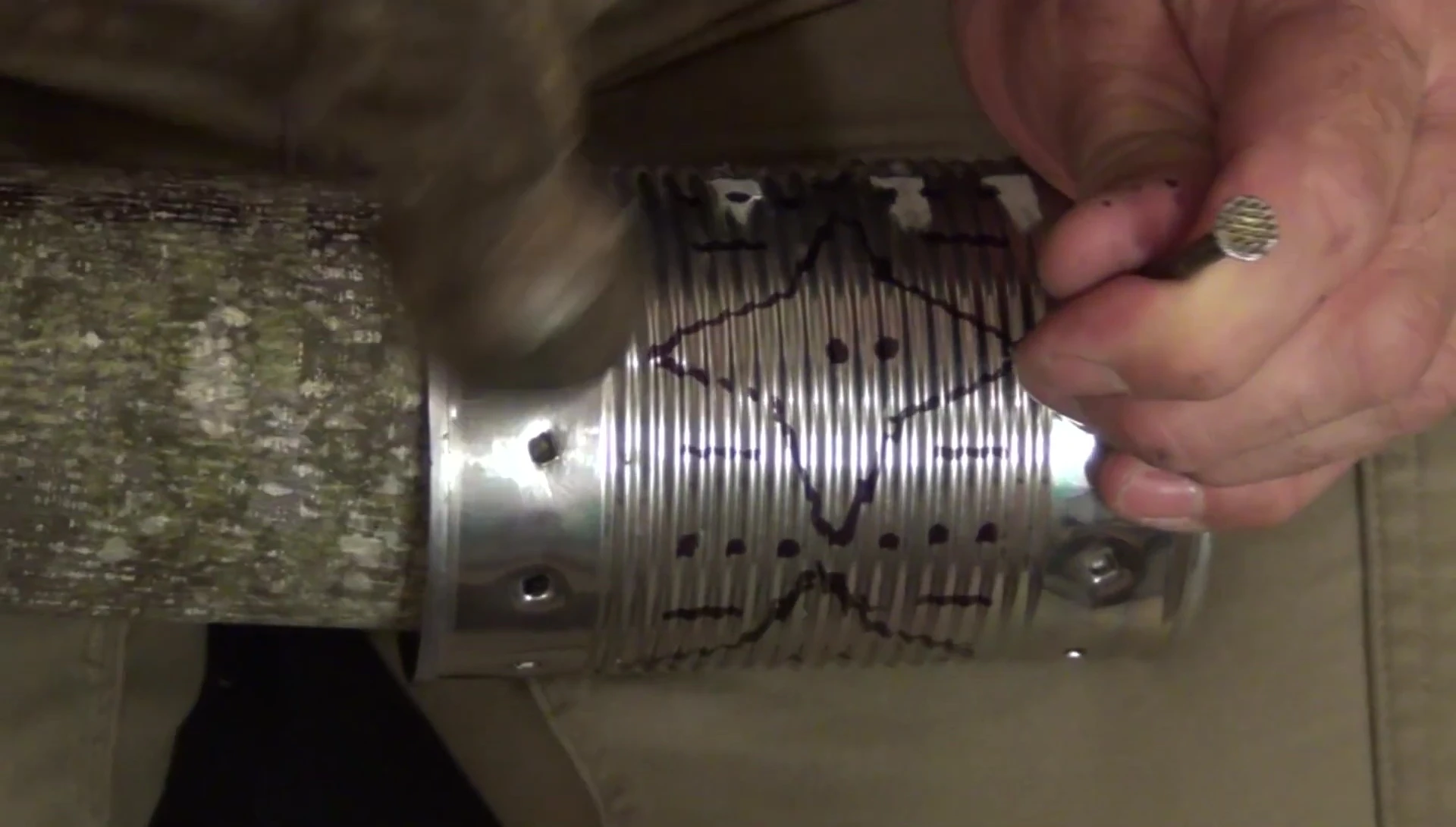 Piercing the star shapes in the tin can with careful attention.