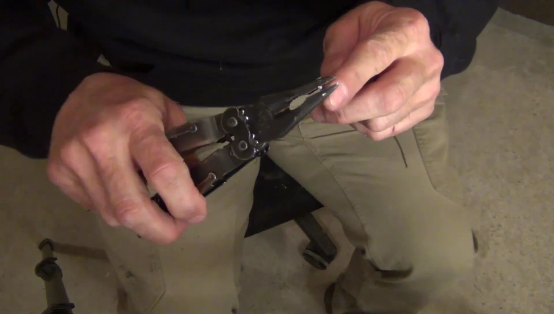 Creating a small hook at the end of the wire hanger with pliers.