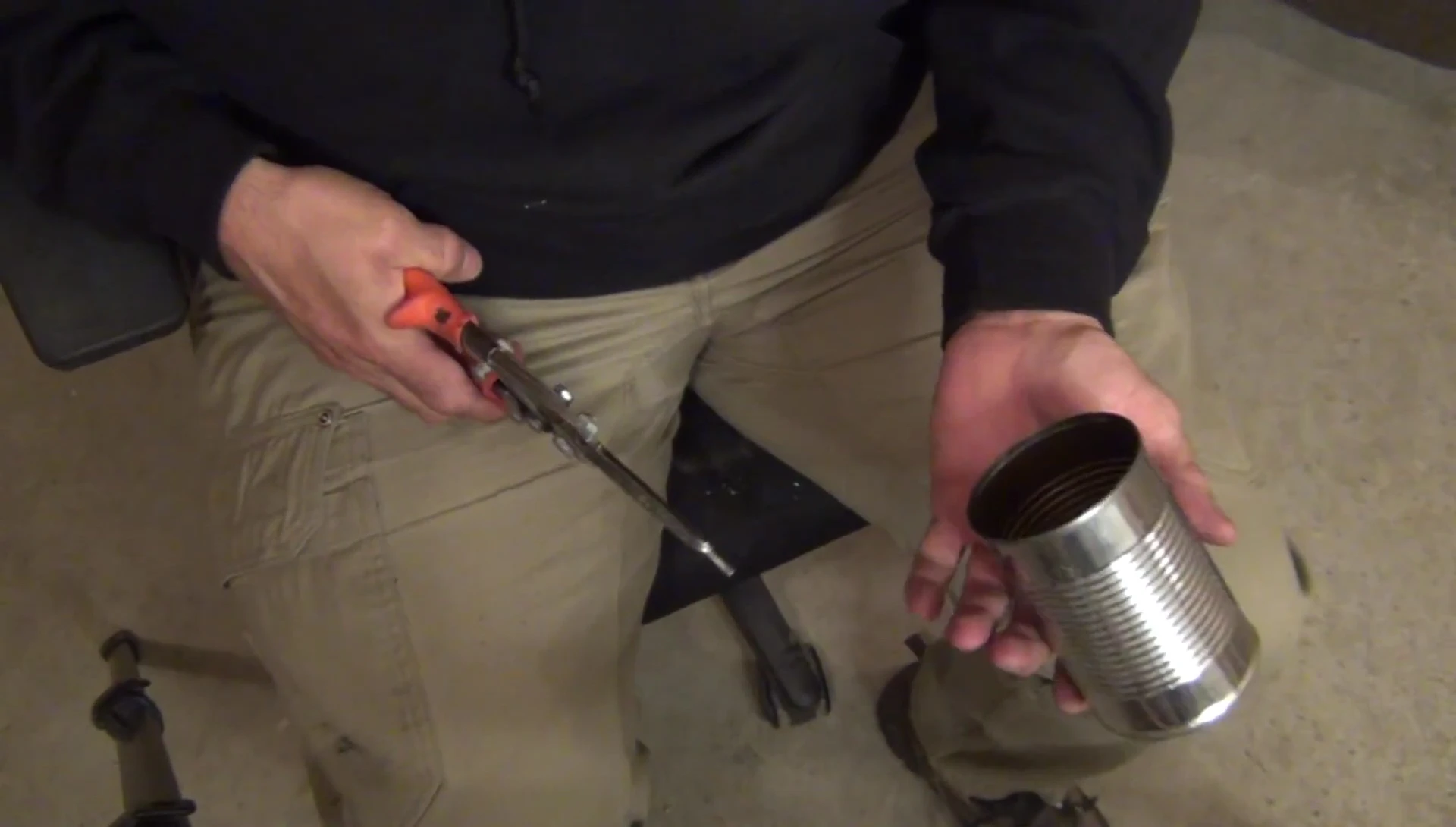 Cutting a second tin can in half to create the top piece.